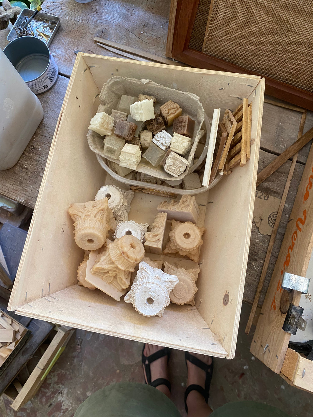 Wooden archive box filled with miniature plaster and resin capitals, rosettes and carved architectural fragments in the Lansdown studio
