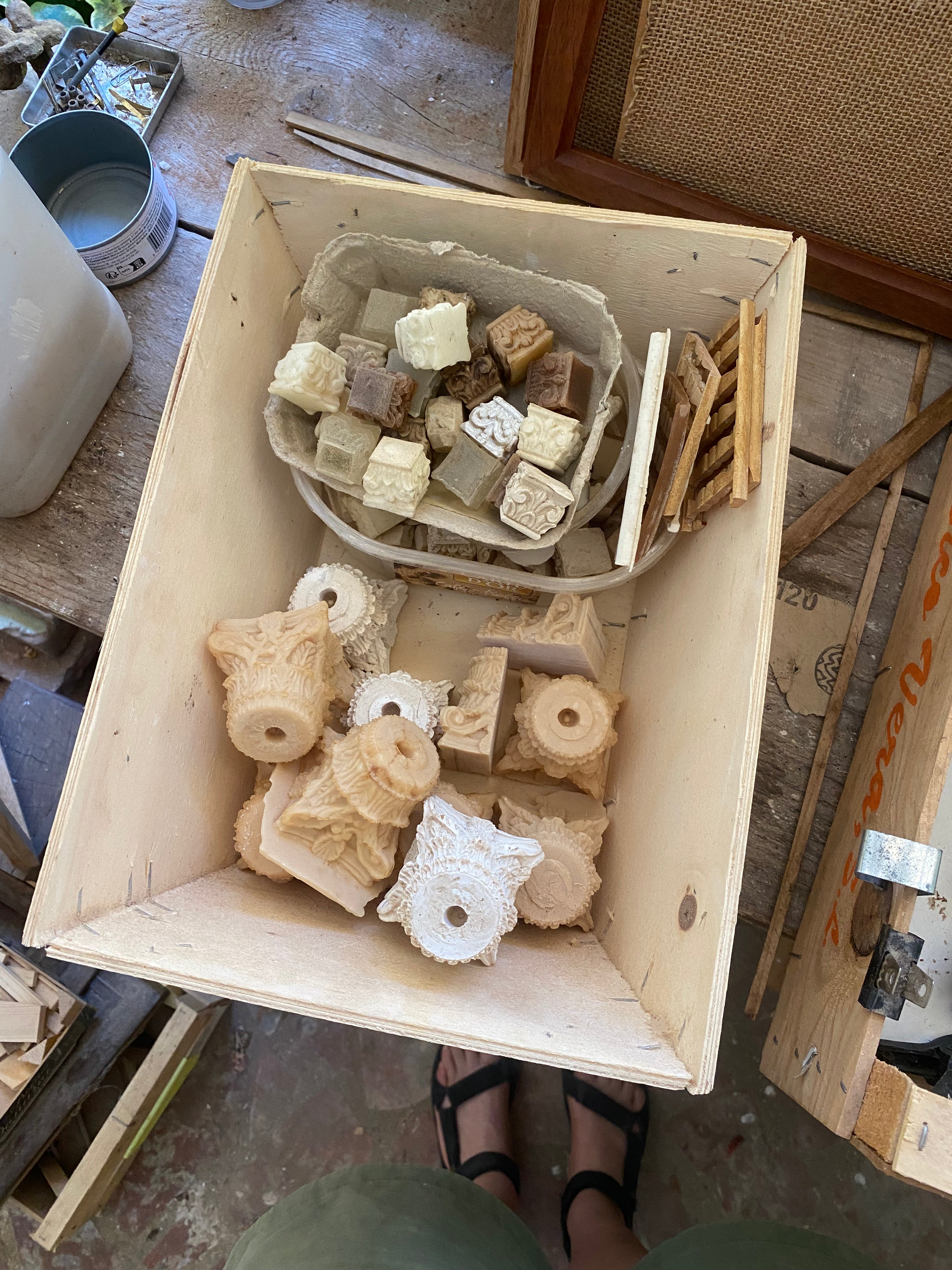 Wooden archive box filled with miniature plaster and resin capitals, rosettes and carved architectural fragments in the Lansdown studio