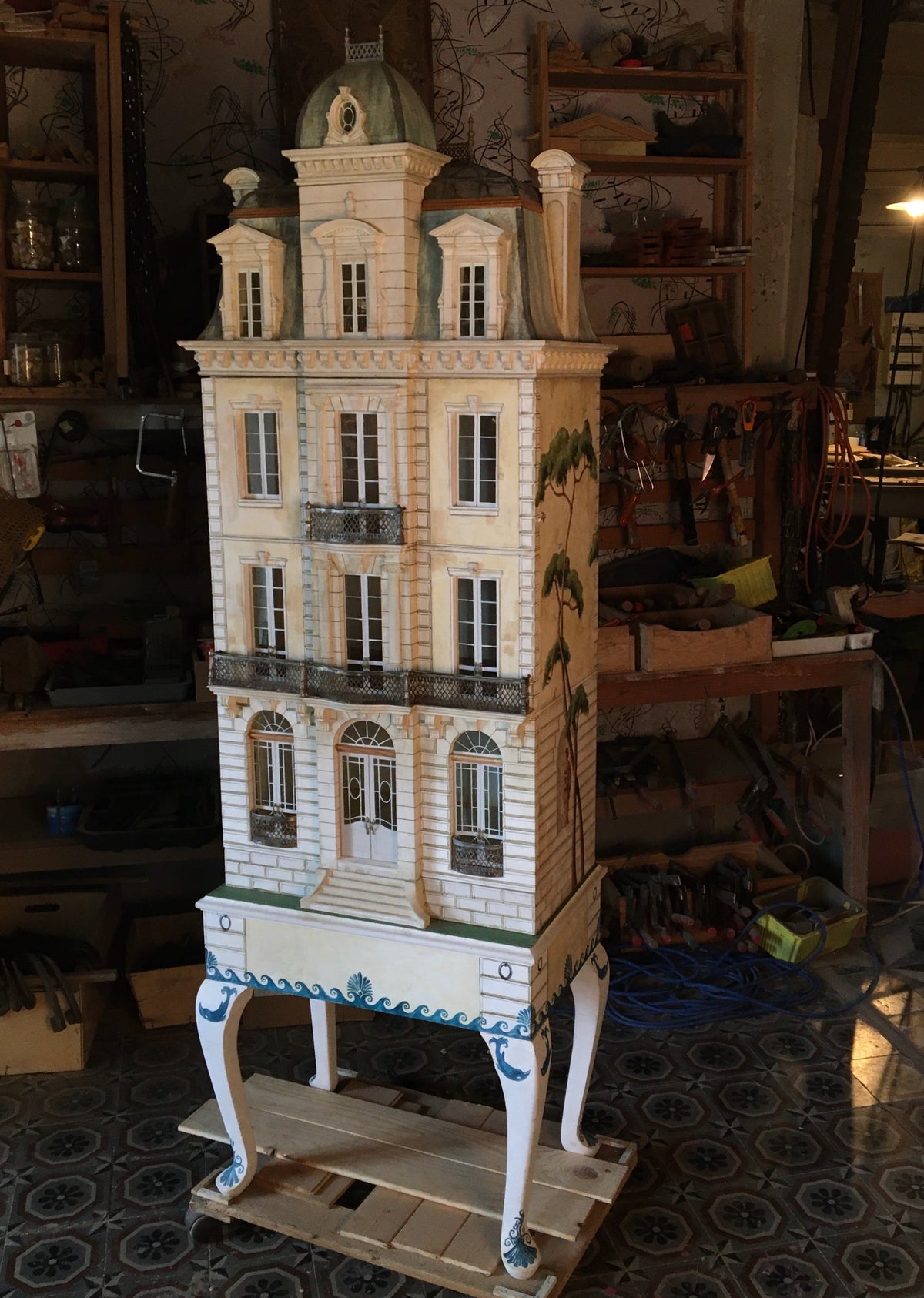 Whitestone Glass Roof House, a handcrafted French architectural dollhouse with pale stone façade and ornate metal balconies.