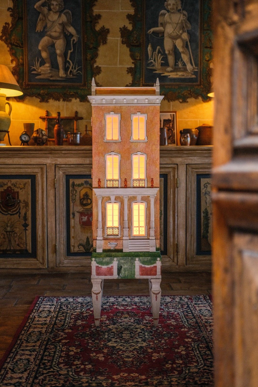 Illuminated Cypress House with an orange hand-painted façade, a collectible architectural dollhouse and heirloom miniature