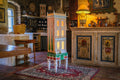 Tall orange Cypress House, a handmade architectural dollhouse displayed as collectible art in a French country interior