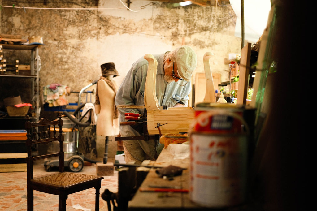 Master craftsman Eric Lansdown hand-building a wooden architectural dollhouse in his studio in Gabian, southern France