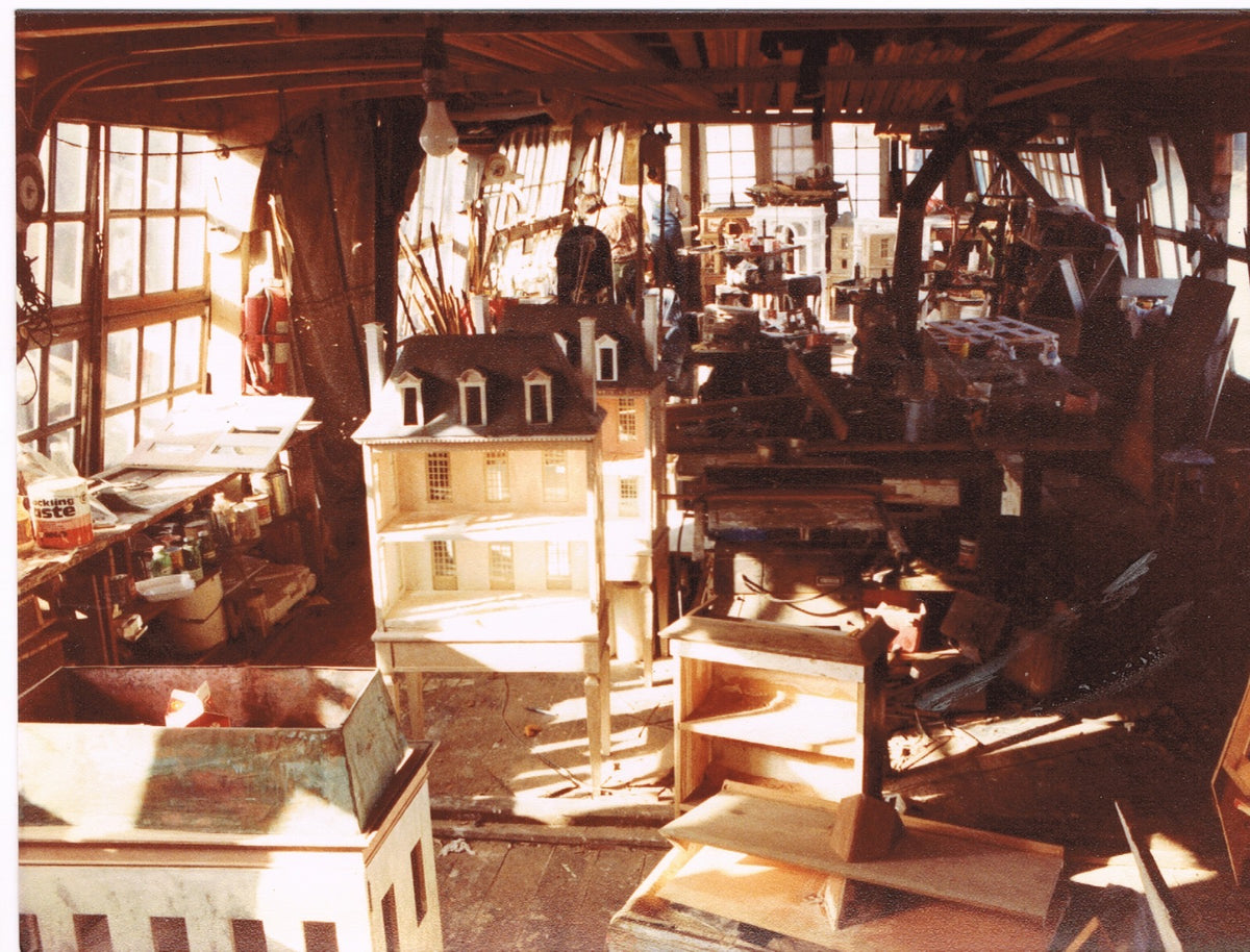 Archival view inside Eric Lansdown’s floating San Francisco studio, with a handmade architectural dollhouse surrounded by tools and works in progress.