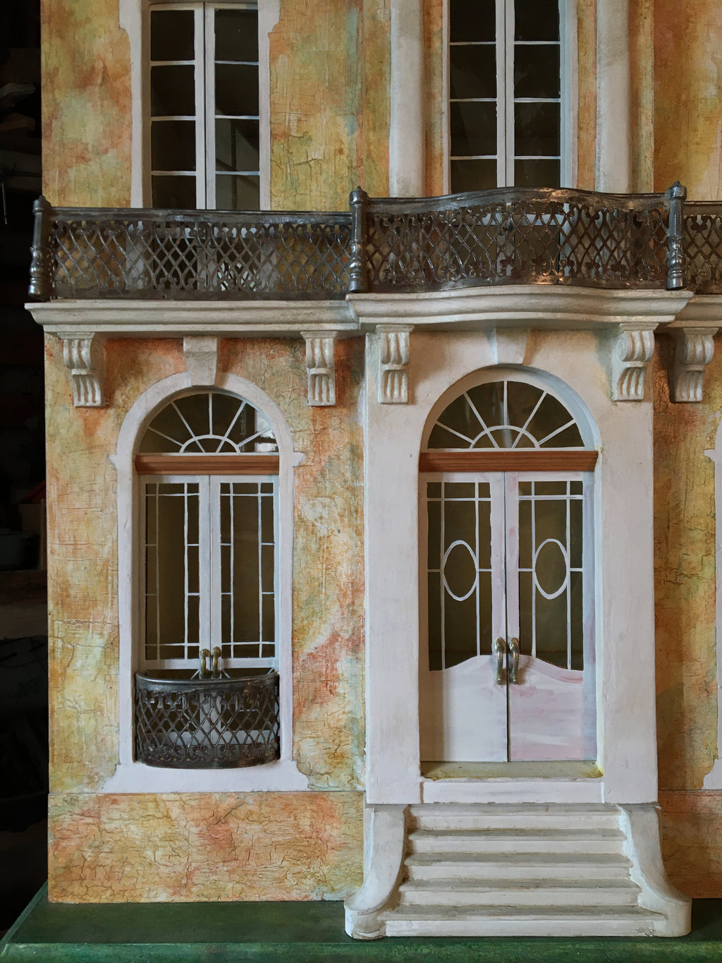 Cypress Tree House upper façade with oval window, carved dormers and aged green mansard roof in French château style.